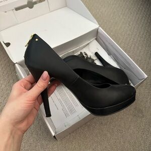 Call it spring black heels with gold zipper detail